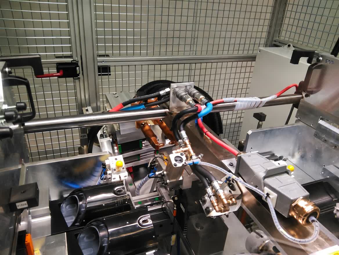 Industrial spot welding gun mounted on robotic arm for automotive body assembly